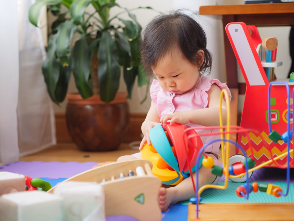 infant playing with Montessori toys