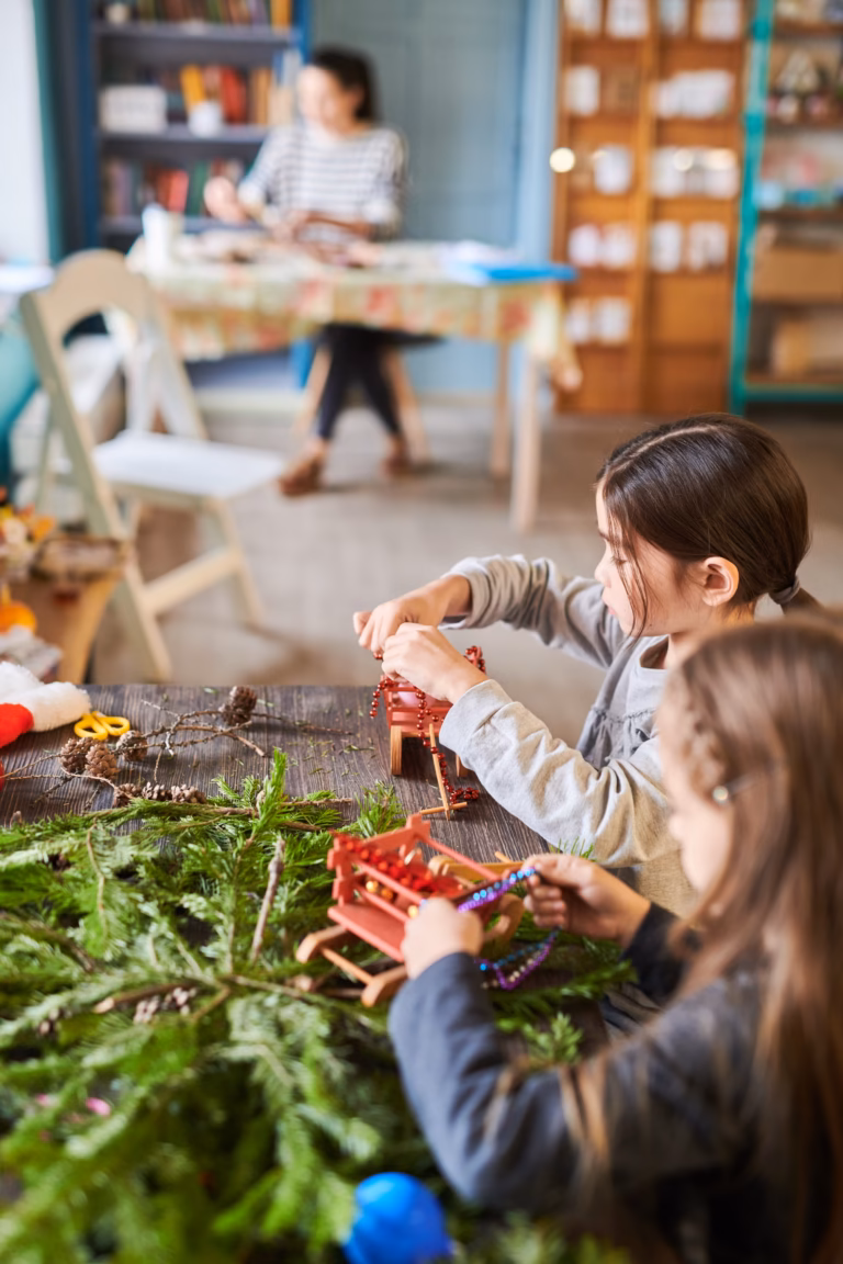 Two children making a nature craft together in the art studio