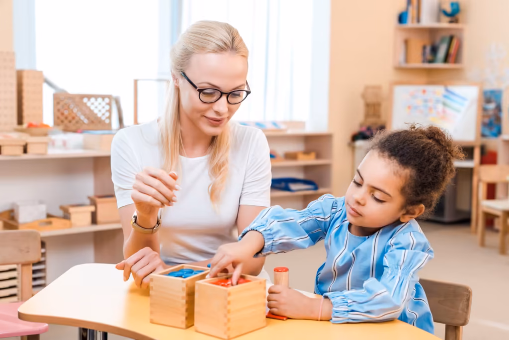 Teacher and child working together with wooden educational materials