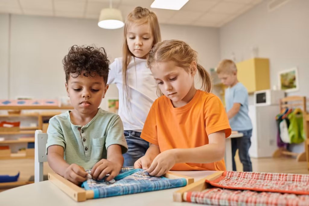 Children practicing new skills together at a table in a bright classroom