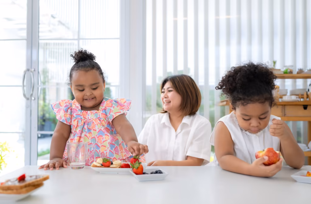 Children preparing and sharing fresh, healthy food together in a bright kitchen