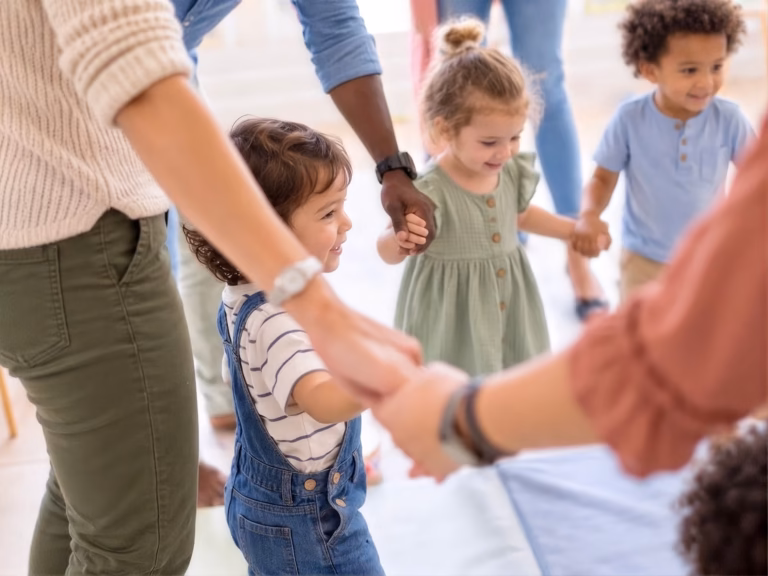 Parents and children holding hands in a circle