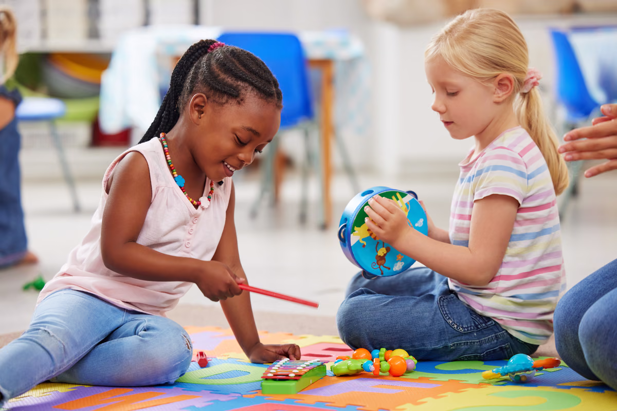 Young children exploring sound with musical instruments